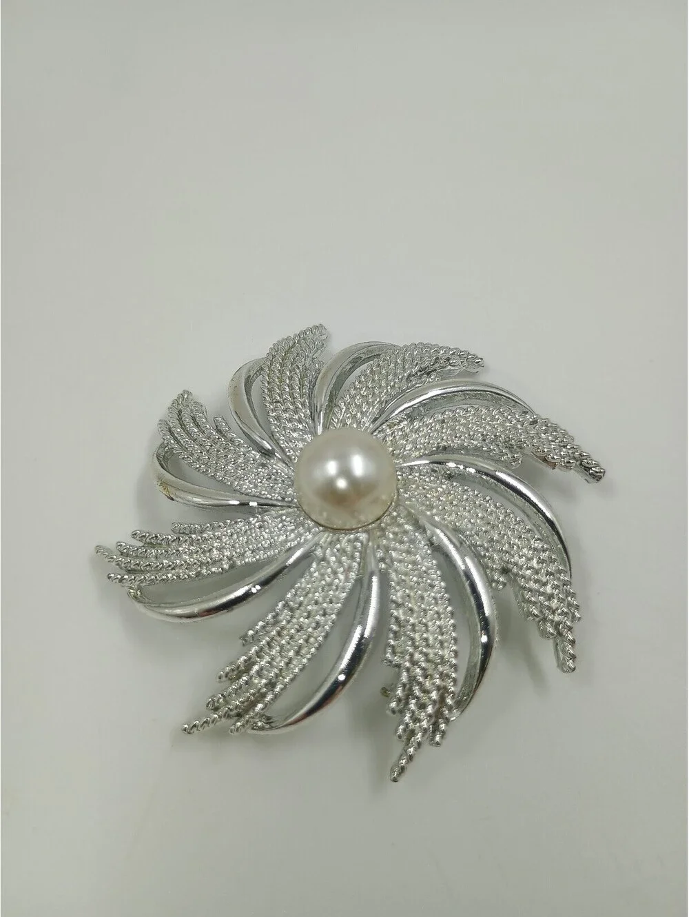 Elegant Silver-Tone Brooch with Pearl Center
